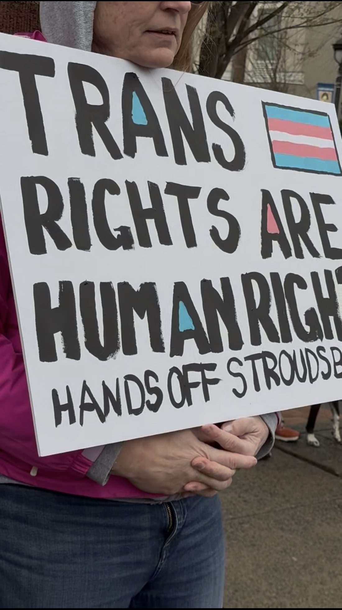 Demonstrator holding a sign at a public gathering
